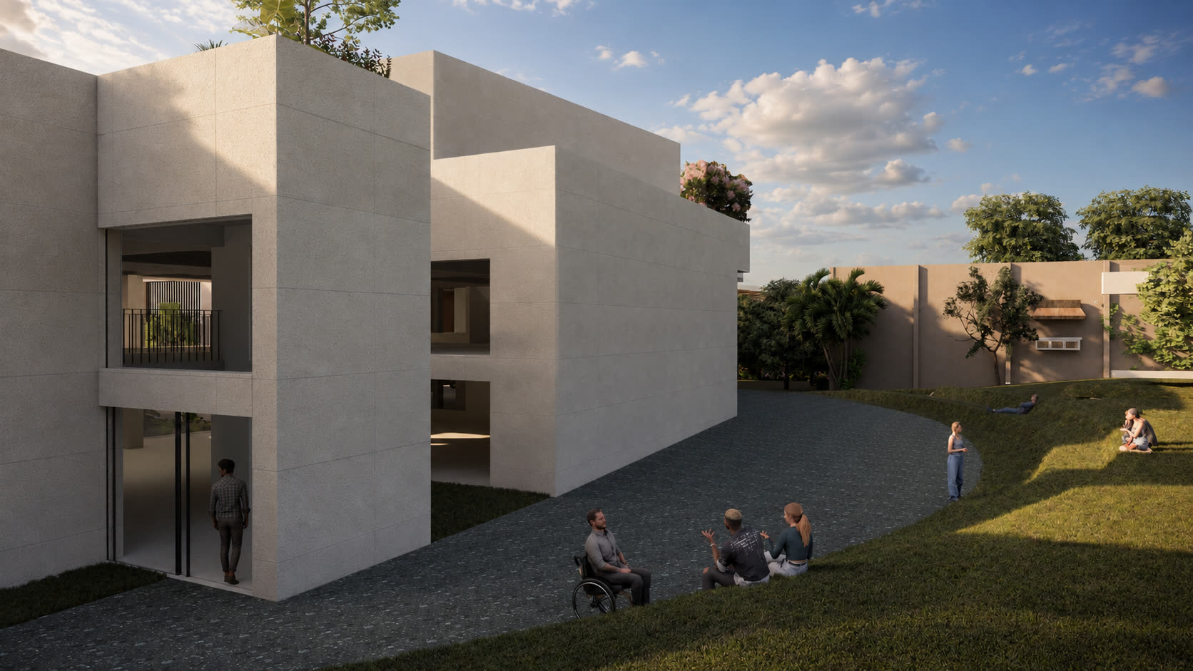 Late-afternoon view of the stone volumes against the garden, with a living wall and figures on the terraced lawn.