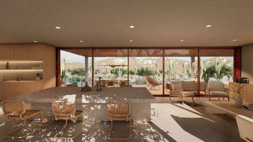 Open living and dining room looking through full-height glass to a wooden terrace and desert landscape.