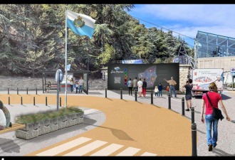 National Transportation Hub plaza at the Borgo Maggiore cable-car station: permeable paving, bus shelter, map kiosk, and San Marino flag.