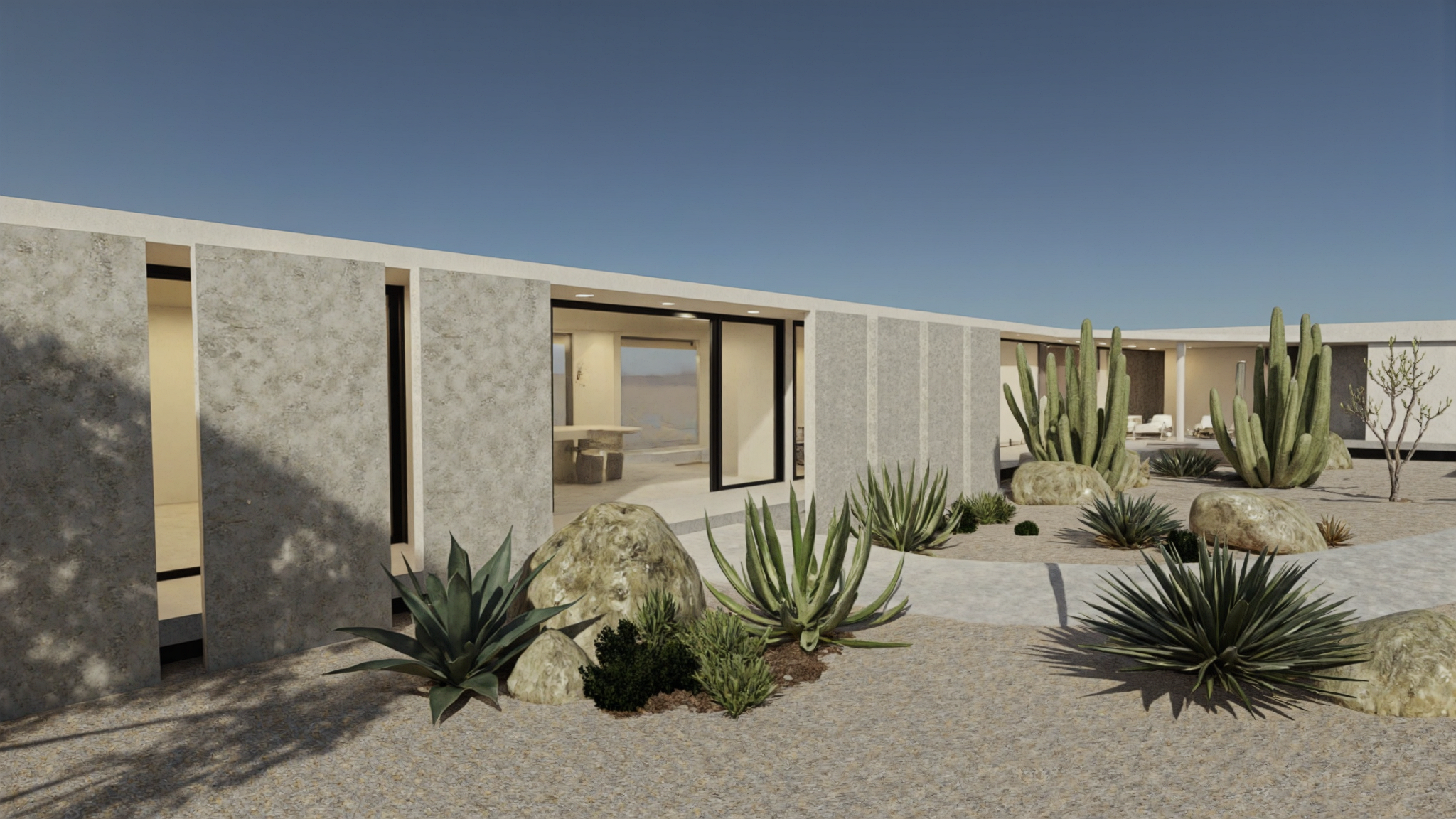 Desert facade with agave, organ-pipe cactus, and boulders; an open black-framed sliding door onto a stone dining table.